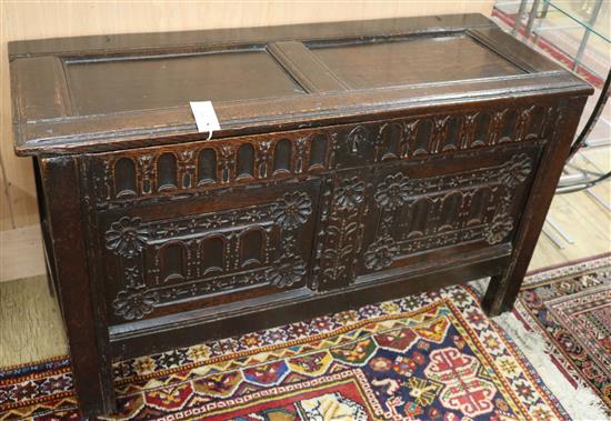 An 18th century carved oak coffer W.110cm